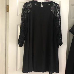 Black mini dress with crocheted sleeves